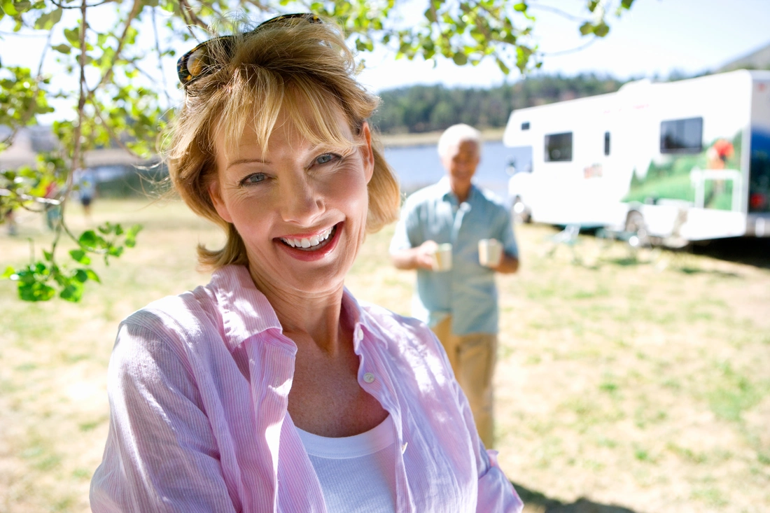 Portrait of woman similing by a campground